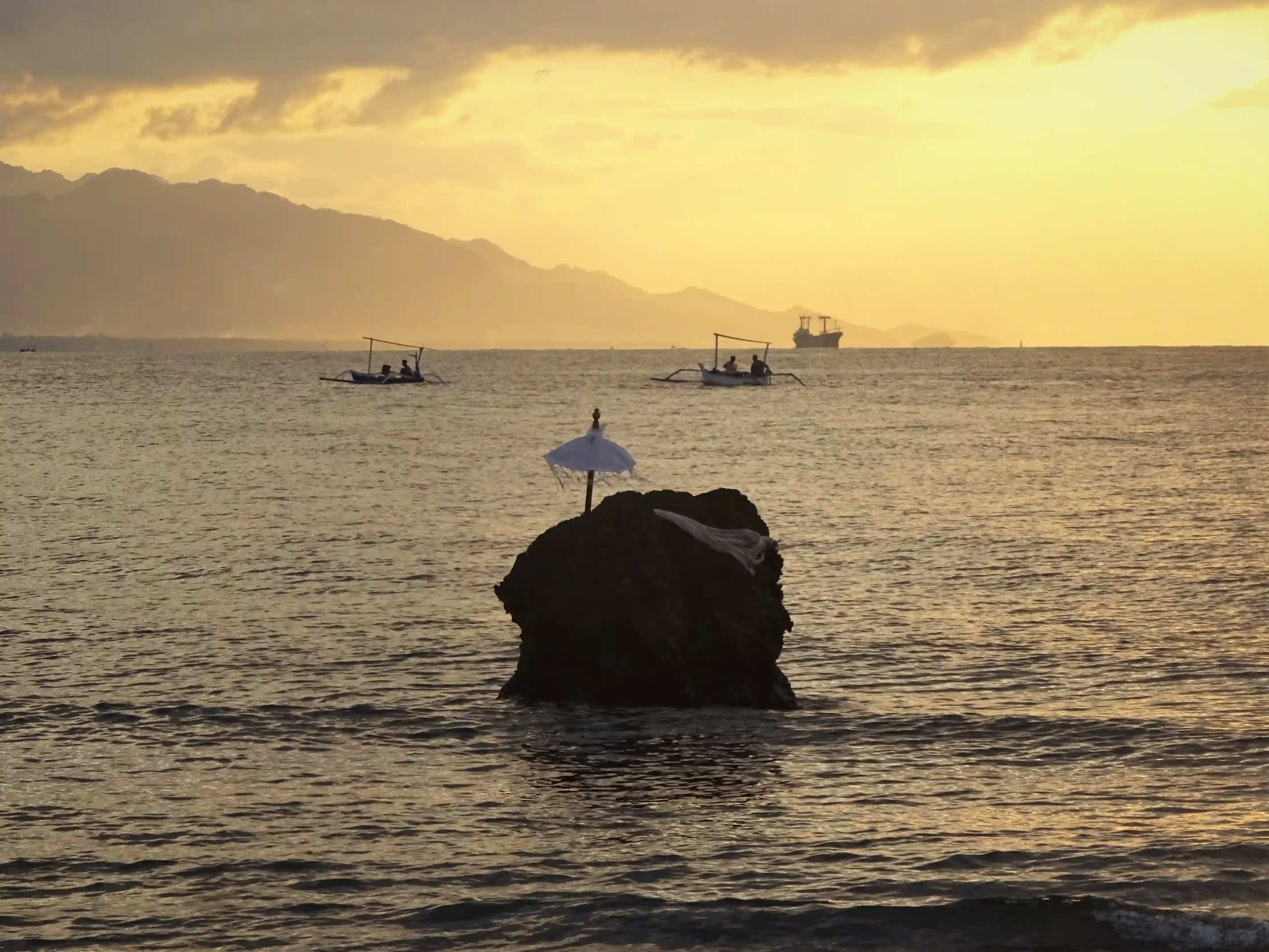 A tropical sunset over the ocean with the activities name 'Bora Bora' displayed in lights over the water.