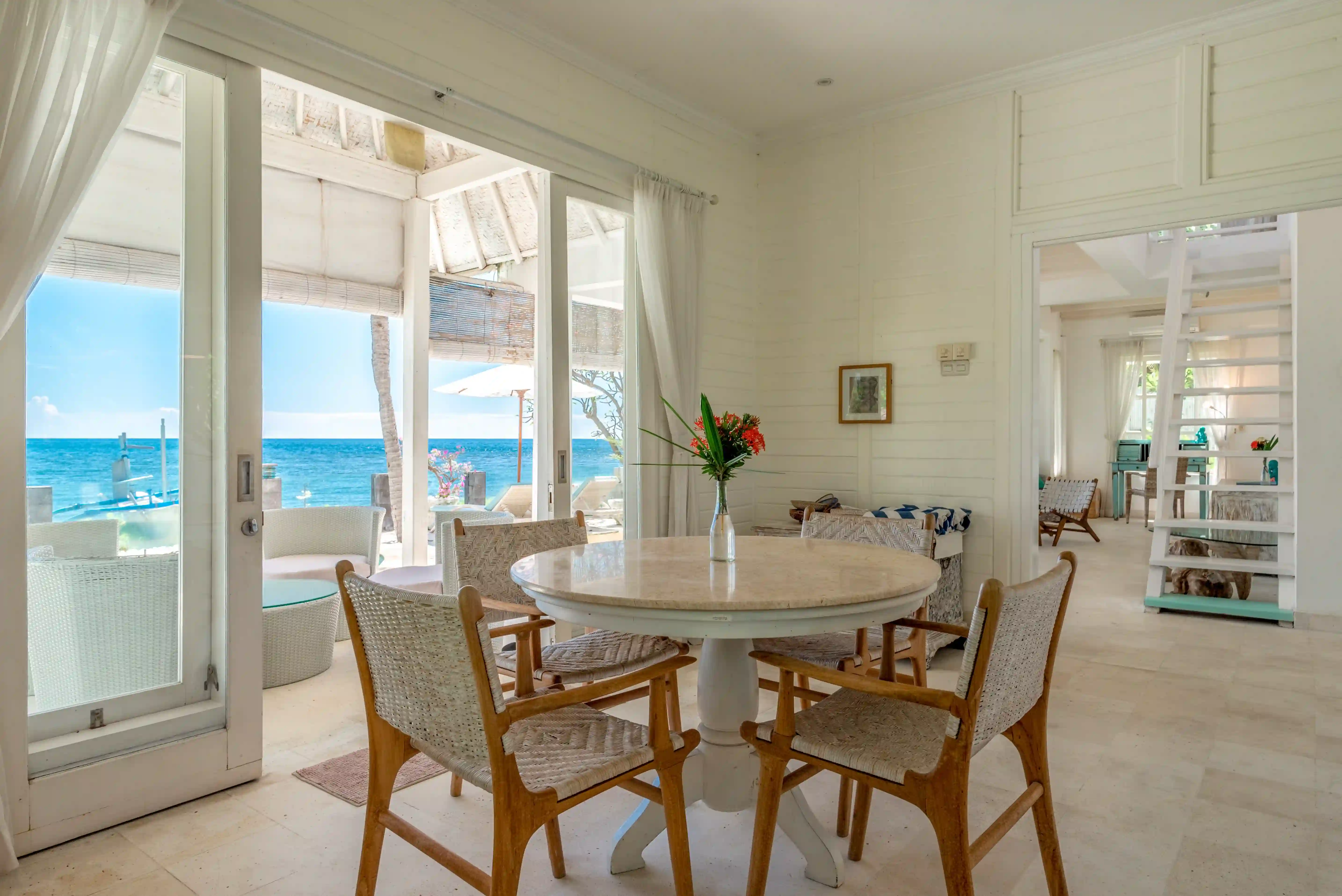 Dining area with ocean view at the beachfront of Mayo Resort Bali