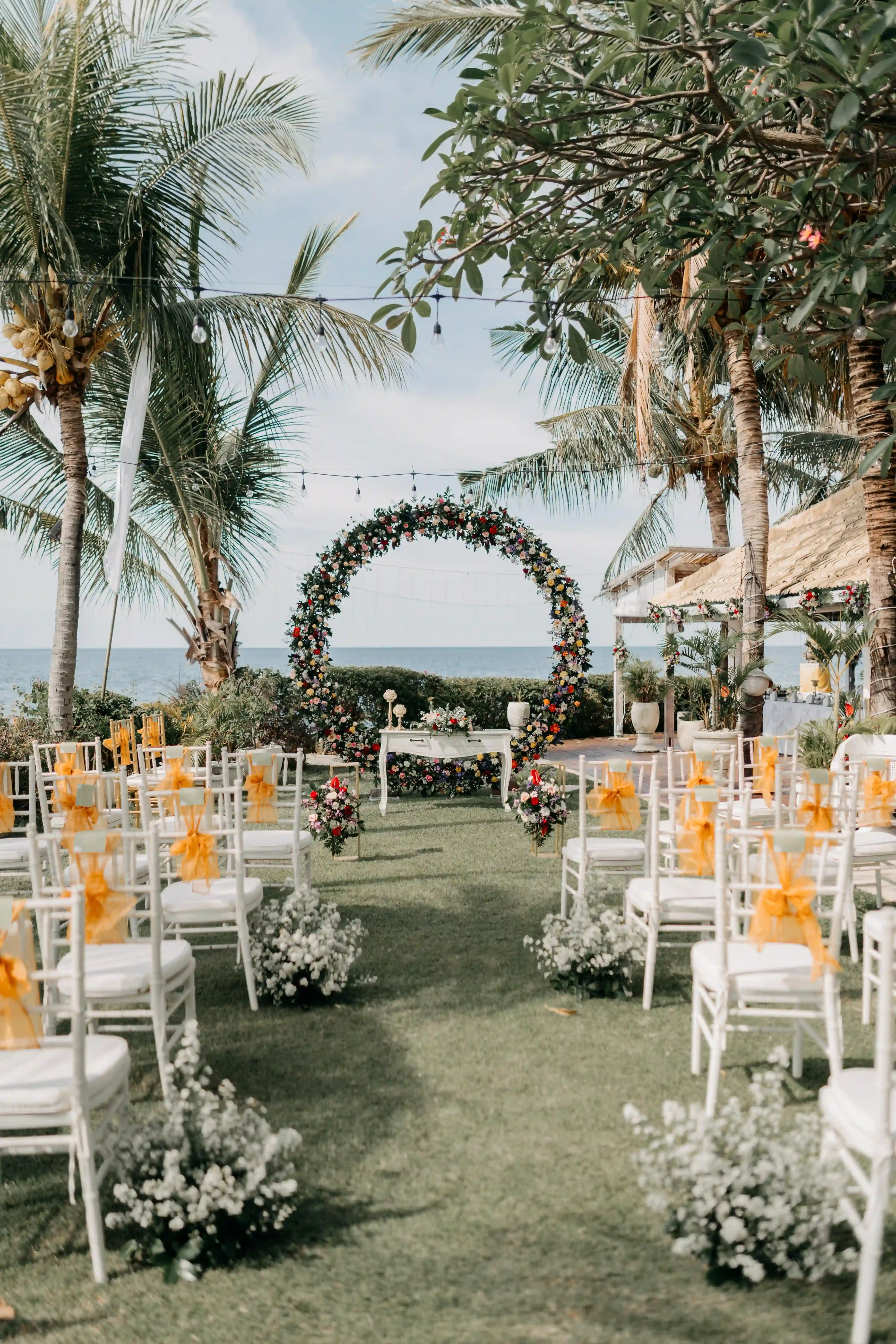 Oceanfront wedding venue at Mayo Resort with decorated seating and floral arrangements