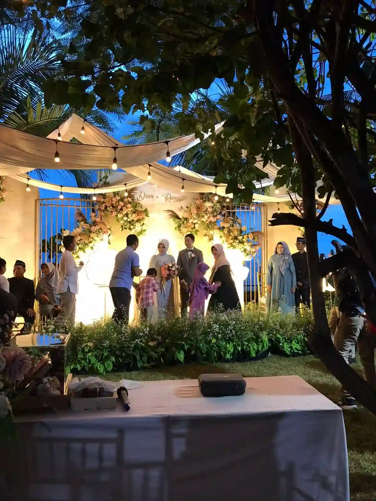 Outdoor wedding reception with guests enjoying the celebration under open sky