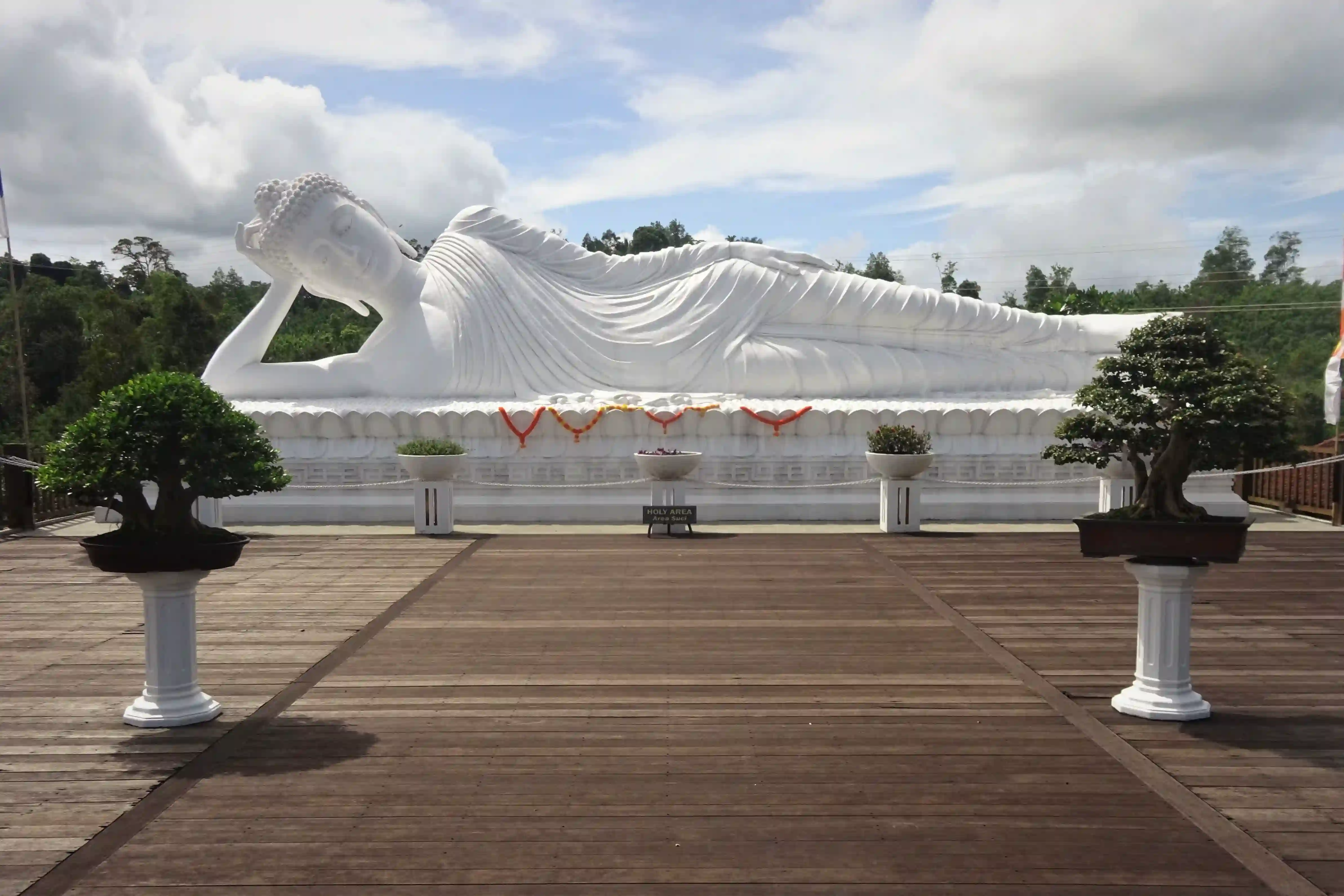Viewpoint overlooking the jungle-covered Mount Batukaru under clear blue sky