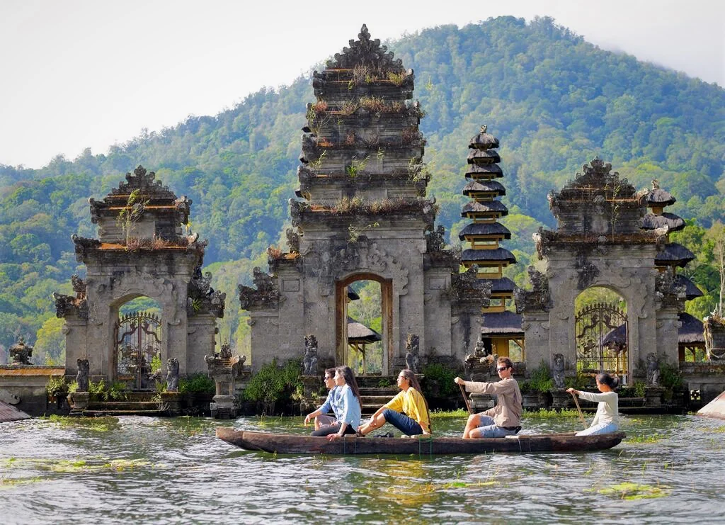 Boats on Lake Tamblingan in Bali with the historical Pura Ulun Danu Tamblingan temple in the background